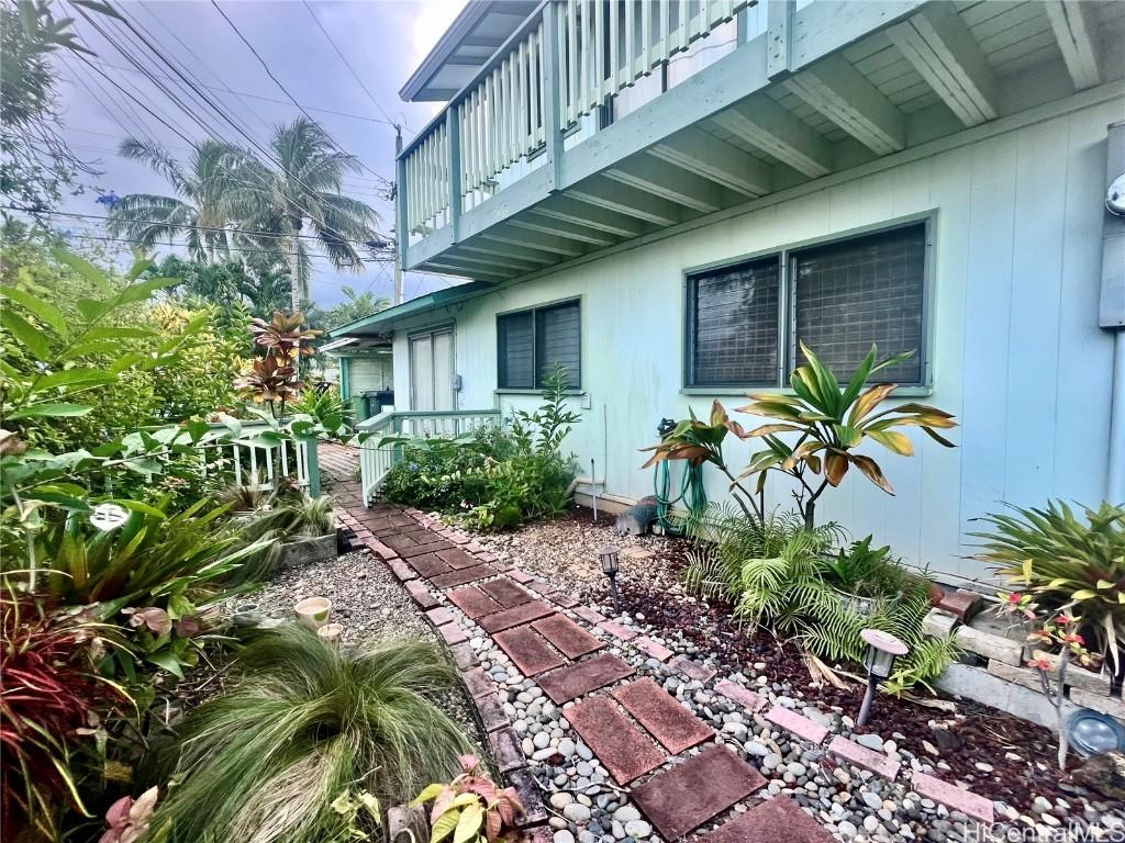 view of side of home featuring a balcony