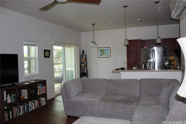 living room with dark wood-type flooring and ceiling fan