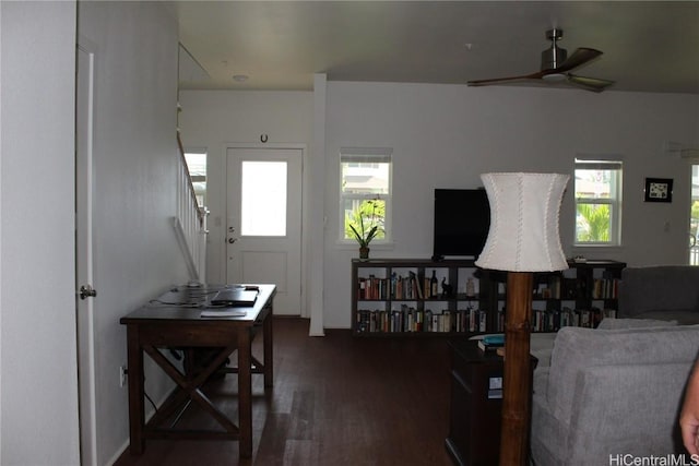 interior space with a ceiling fan, a wealth of natural light, dark wood finished floors, and stairway