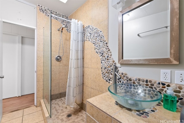 full bathroom featuring a stall shower and tile patterned floors