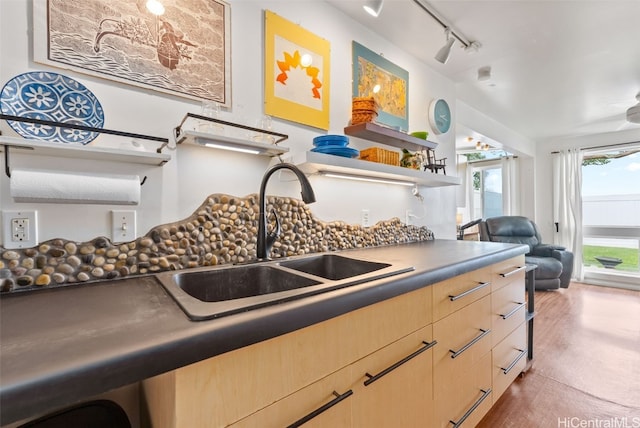 kitchen with open floor plan, rail lighting, light brown cabinets, open shelves, and a sink