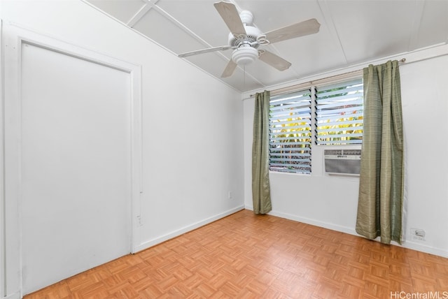 empty room featuring a ceiling fan and baseboards