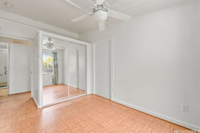 unfurnished bedroom featuring ceiling fan, a closet, and baseboards