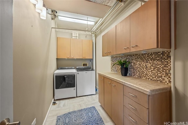 laundry room featuring cabinet space, baseboards, and independent washer and dryer