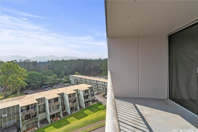 balcony featuring a wooded view