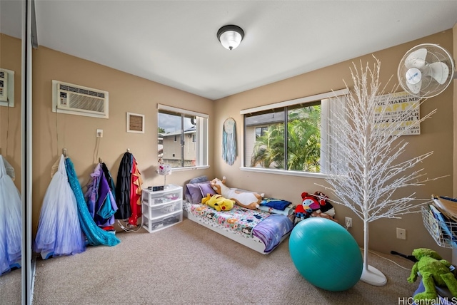 bedroom with an AC wall unit, a closet, carpet, and visible vents