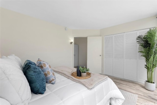 bedroom featuring a closet and light wood-style floors