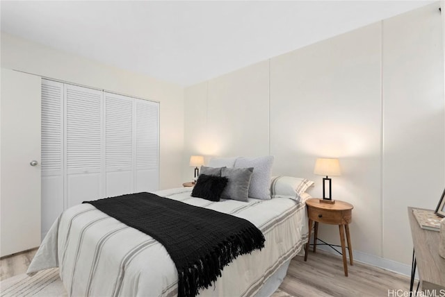 bedroom featuring light wood-type flooring and a closet