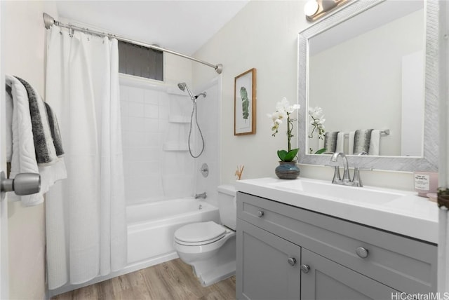 bathroom with vanity, toilet, shower / tub combo with curtain, and wood finished floors