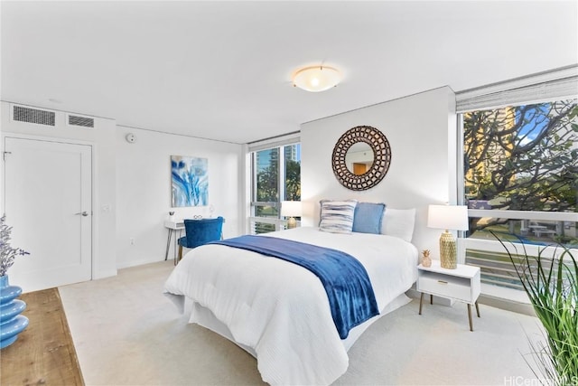 bedroom with light carpet and visible vents