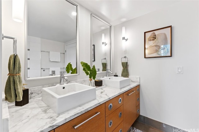 bathroom featuring a sink and double vanity