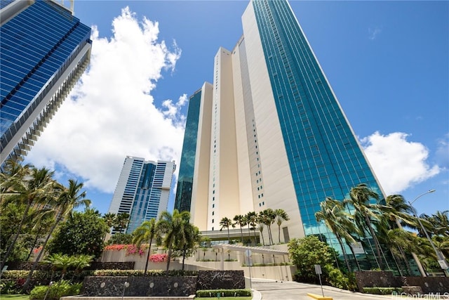 view of building exterior featuring fence and a city view