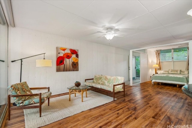 living area with ceiling fan and wood finished floors