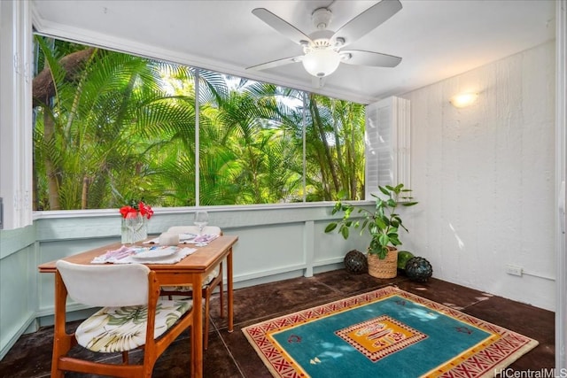 sunroom featuring a ceiling fan