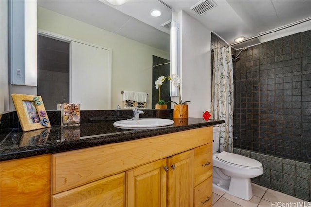 full bath with tile patterned flooring, toilet, vanity, visible vents, and tiled shower