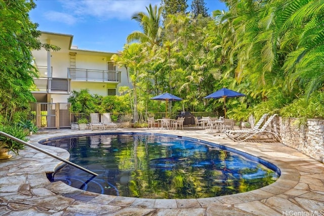 community pool featuring a patio area and fence