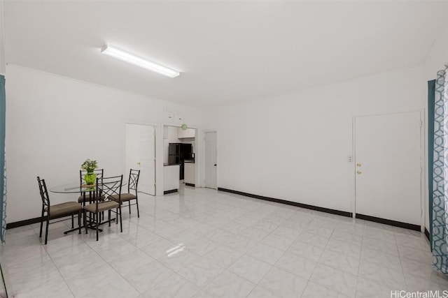 dining space featuring baseboards