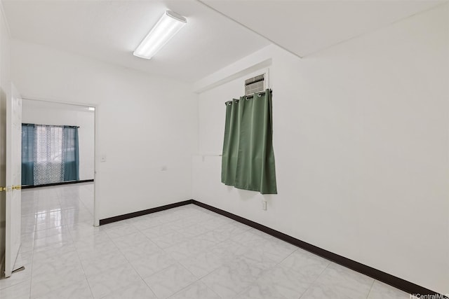 unfurnished room featuring baseboards