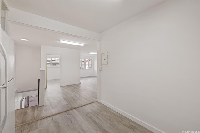 empty room with baseboards and wood finished floors