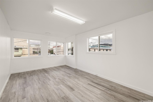 unfurnished room featuring wood finished floors and baseboards