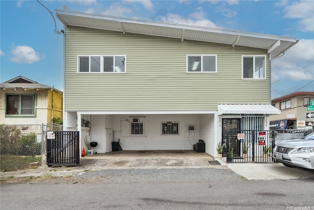 view of front of home with a carport and fence