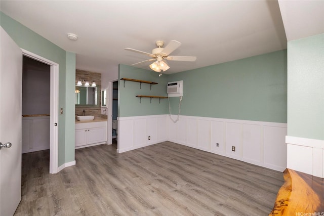 91-1016C Hoomaka St Unit 78, Ewa Beach, HI 96706 - unfurnished room featuring a wall mounted air conditioner, a smoke detector, a wainscoted wall, a ceiling fan, and light wood-type flooring