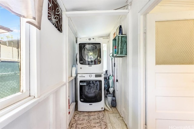 clothes washing area featuring laundry area and stacked washer / drying machine