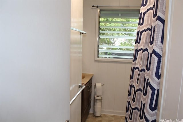 full bath with a shower with shower curtain, tile patterned floors, and vanity