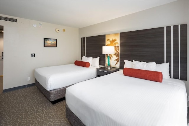 bedroom featuring visible vents, dark carpet, and baseboards