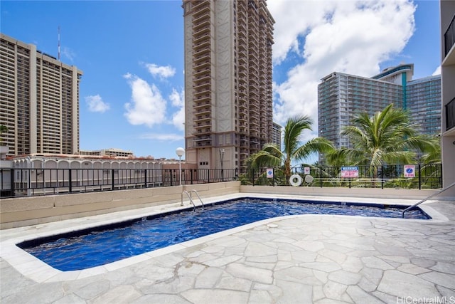 pool with fence and a patio