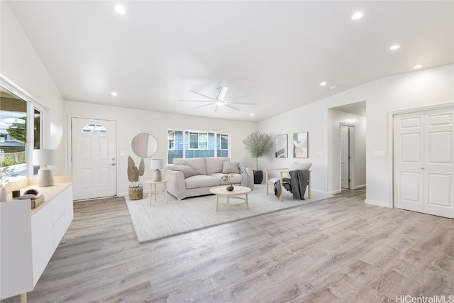 living area with a ceiling fan, lofted ceiling, recessed lighting, and light wood-type flooring