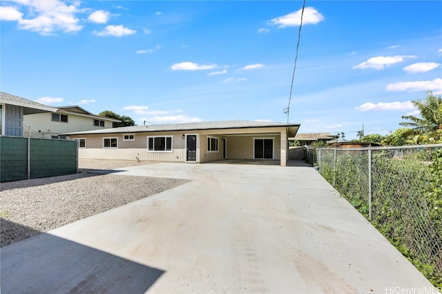 ranch-style house with driveway and fence