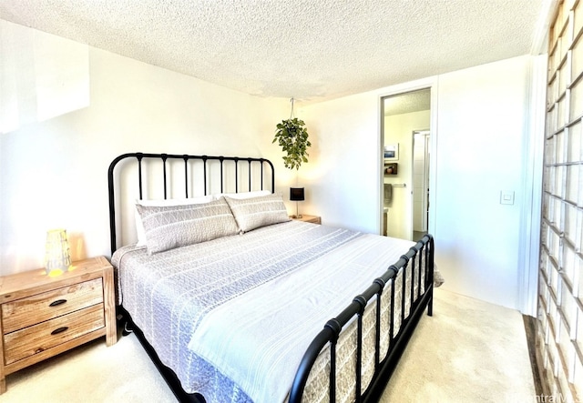 bedroom with light carpet and a textured ceiling