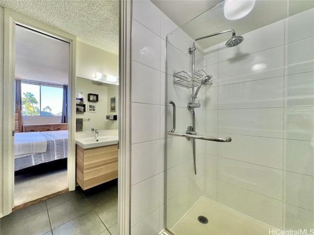 bathroom with a textured ceiling, ensuite bath, a stall shower, and tile patterned flooring