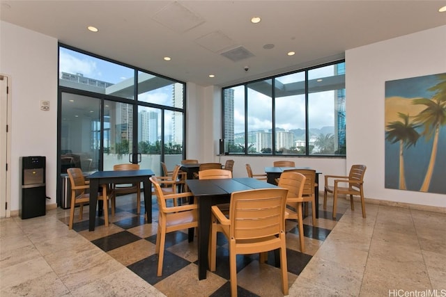 dining space featuring baseboards and recessed lighting