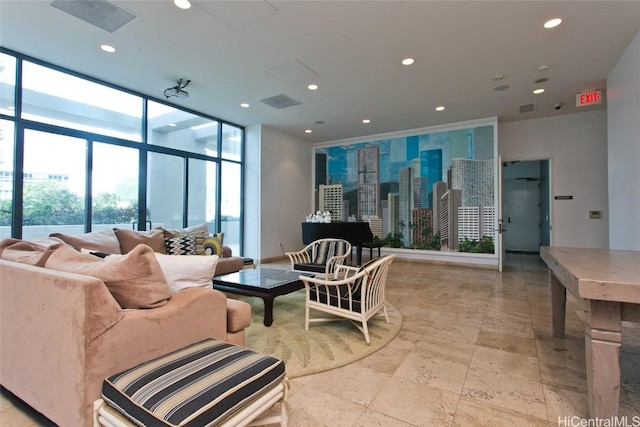 living room featuring a view of city, visible vents, a wall of windows, and recessed lighting