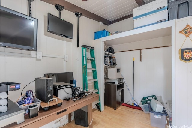 home office featuring beamed ceiling and light wood-style flooring