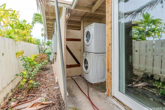 exterior space featuring laundry area and stacked washing maching and dryer