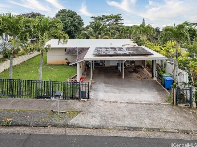 view of front of home with a fenced front yard, a front yard, concrete driveway, and an attached carport