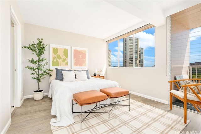 bedroom with baseboards and wood finished floors