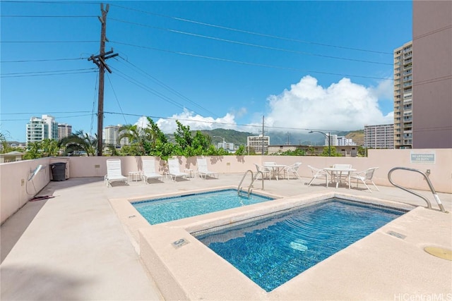 community pool featuring a patio area and fence