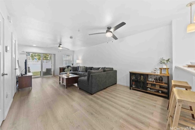 living room with ceiling fan and light wood-style floors