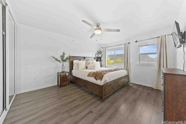 bedroom with dark wood-type flooring, ceiling fan, and baseboards