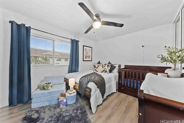 bedroom with ceiling fan and light wood-type flooring