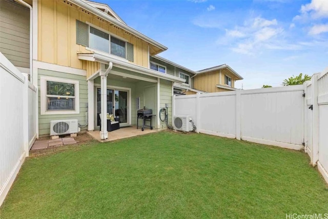 rear view of property with ac unit, a fenced backyard, board and batten siding, and a yard