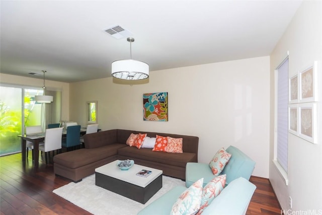 living room featuring dark wood-style floors and visible vents