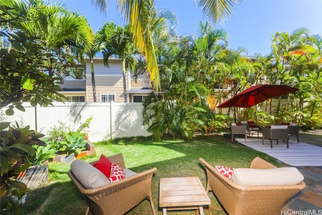 view of yard with fence, outdoor lounge area, and a wooden deck