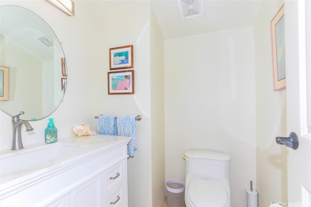 bathroom with visible vents, vanity, and toilet