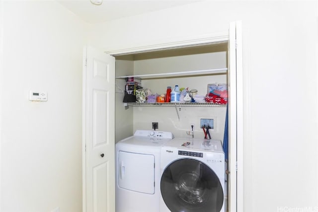 washroom featuring laundry area and washing machine and dryer