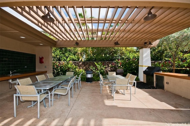 view of patio / terrace with a sink, a grill, outdoor dining area, and a pergola